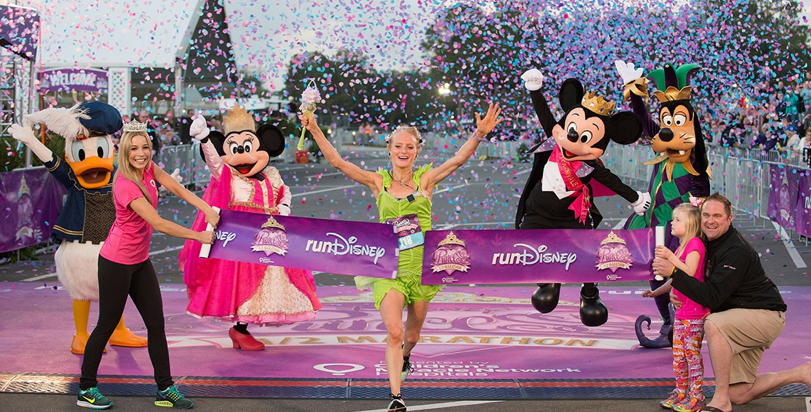 Runner crossing the finish line at a runDisney Princess Half Marathon